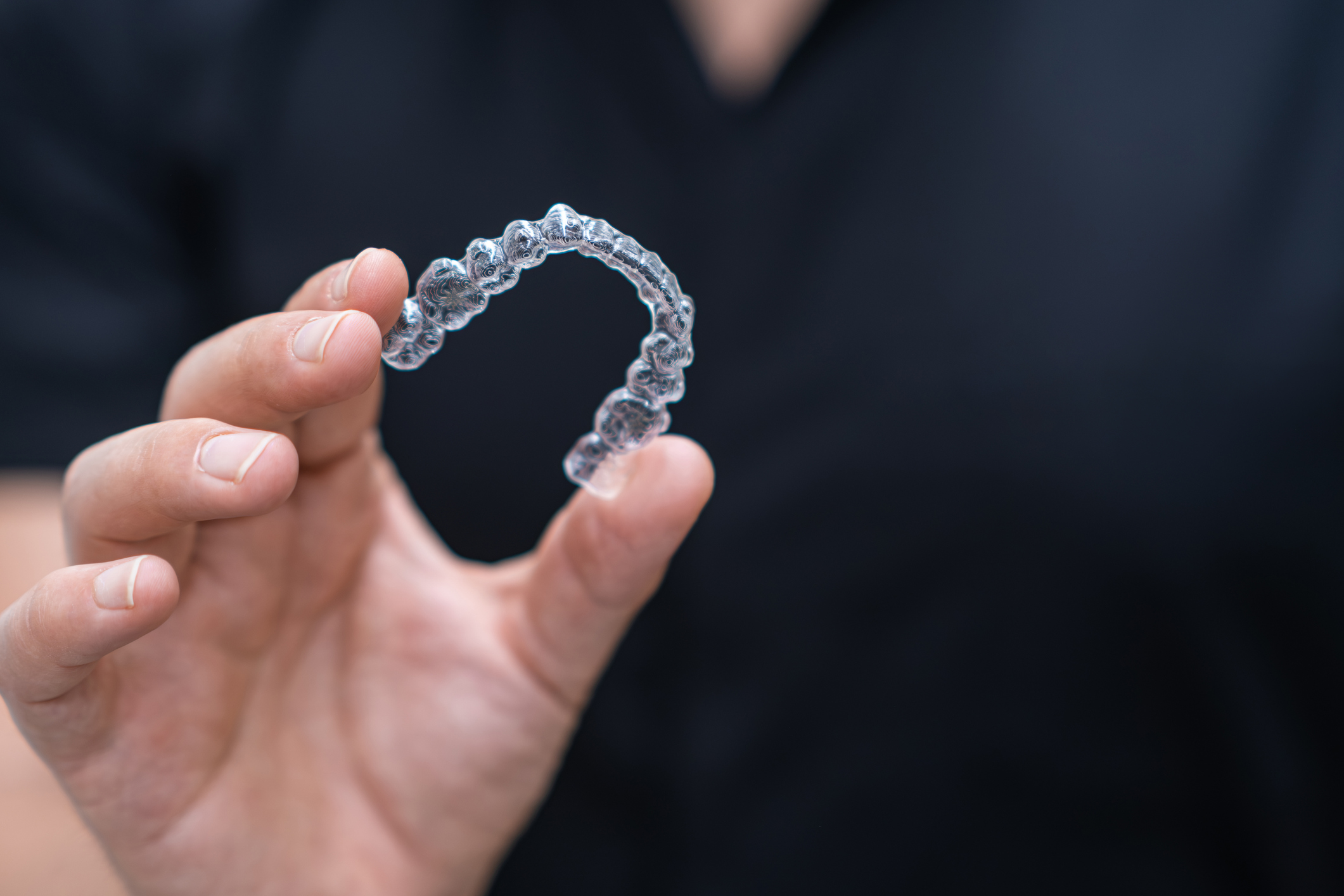 Dentist holding clear aligners Dentist holding clear aligners